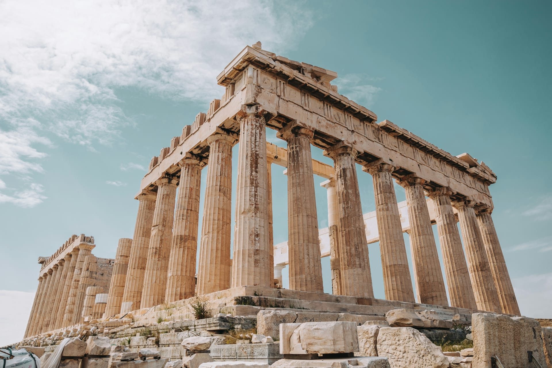 The Parthenon on the Acropolis of Athens at sunset, with the golden light reflecting off the marble columns